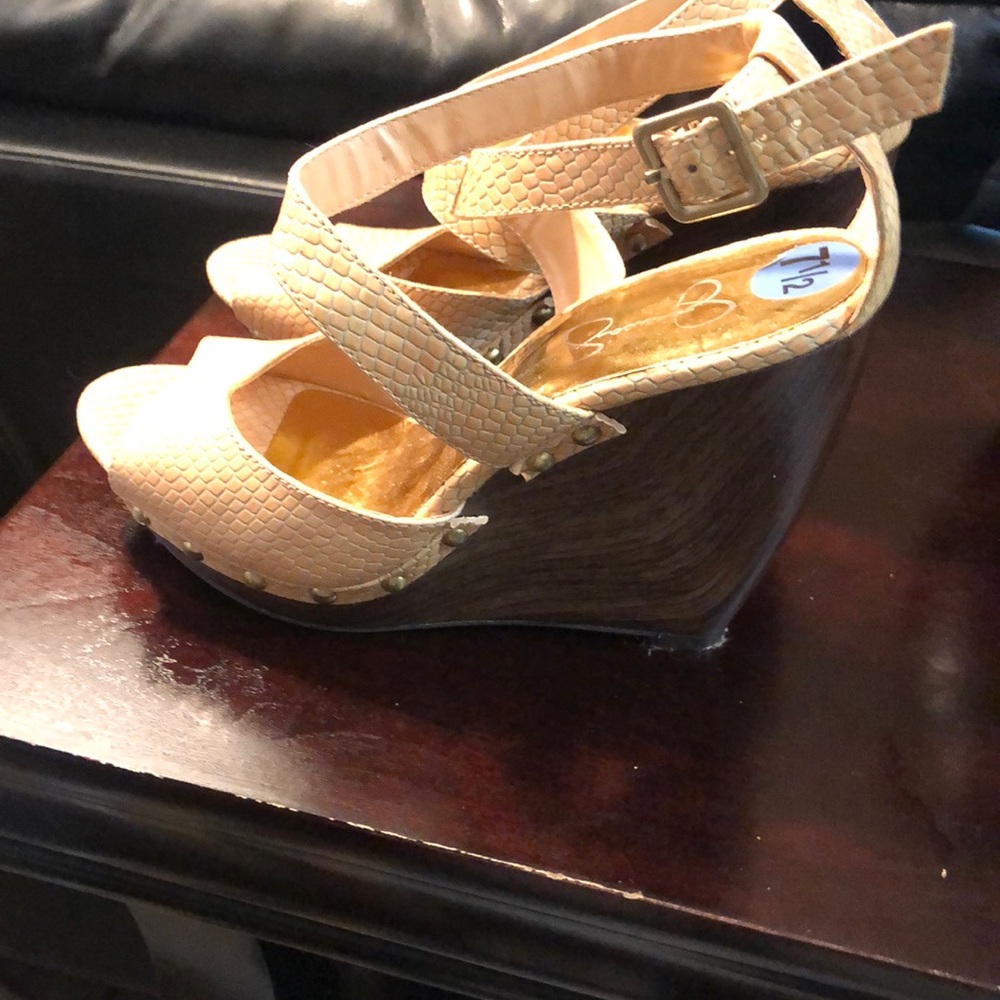 Jessica Simpson wedged heel sandal with gold stubs around the bed of the shoe.